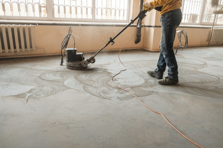 man with an equipment and finishing the concrete